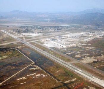Aerial view of mountains, runway, and buildings at NAS Point Mugu Navy Base in Poing Mugu, CA