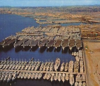 Vintage aerial view of dozens of US Navy ships at port at NS San Diego Navy Base in San Diego, CA