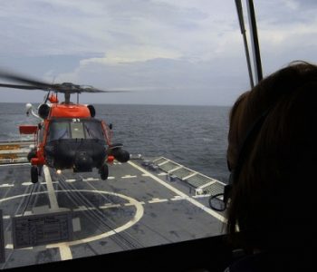 Helicopter landing on a surface vessel stationed at Aviation Training Center Coast Guard Base in Mobile, AL