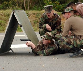 U.S. military members performing weapons training with a handgun at Fleet Activities Okinawa Naval Base in Okinawa, Japan
