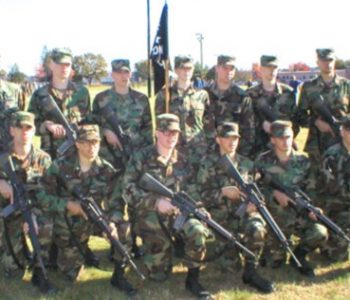 U.S. Army soldiers posing with weapons at Fort Devens Army Base in Devens, MA