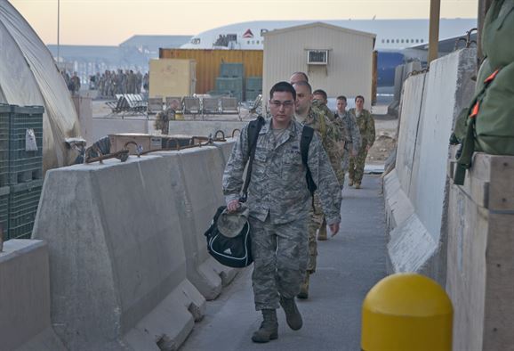 US Air Force members waking by concrete retaining wall at Al Udeid, Qatar