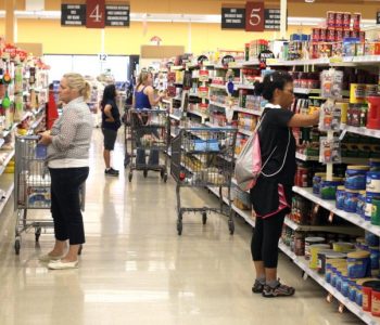 A group of people grocery shopping at the Bangor ANGB Commissary