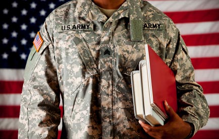 Army soldier holding college textbooks.